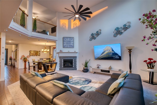 living room featuring hardwood / wood-style floors, a chandelier, and a high ceiling