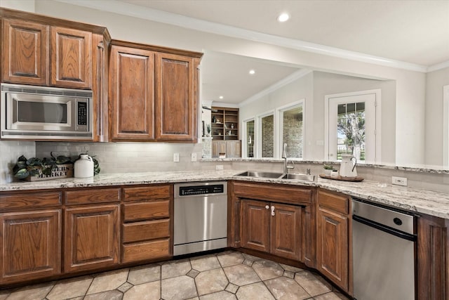 kitchen with sink, stainless steel appliances, ornamental molding, light stone countertops, and decorative backsplash