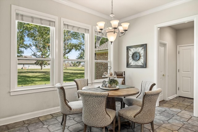 dining room with ornamental molding and a chandelier