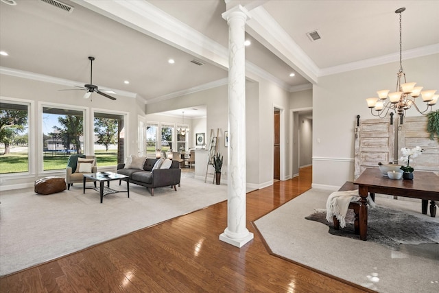 interior space with ornate columns, hardwood / wood-style flooring, and ceiling fan with notable chandelier