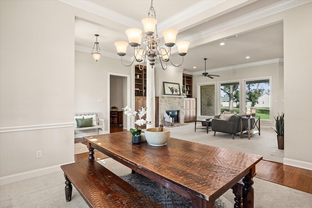 dining room with crown molding, ceiling fan with notable chandelier, and light hardwood / wood-style floors