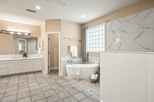 bathroom featuring vanity, a tub, and ceiling fan