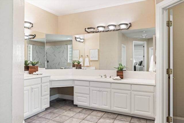 bathroom with tile patterned flooring, vanity, ceiling fan, and walk in shower