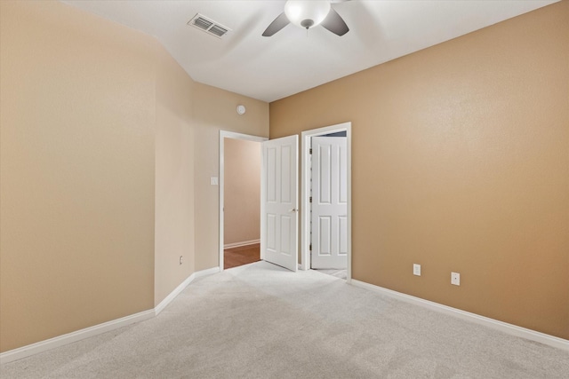 unfurnished bedroom with light colored carpet and ceiling fan