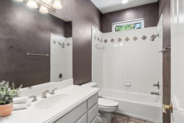 full bathroom with vanity, tiled shower / bath combo, and toilet