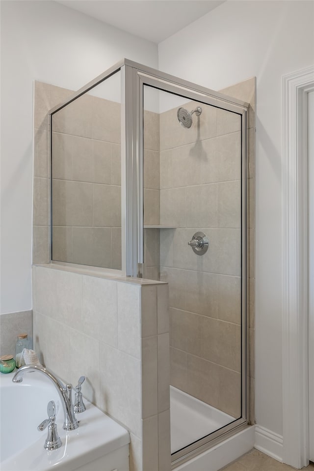 bathroom featuring separate shower and tub