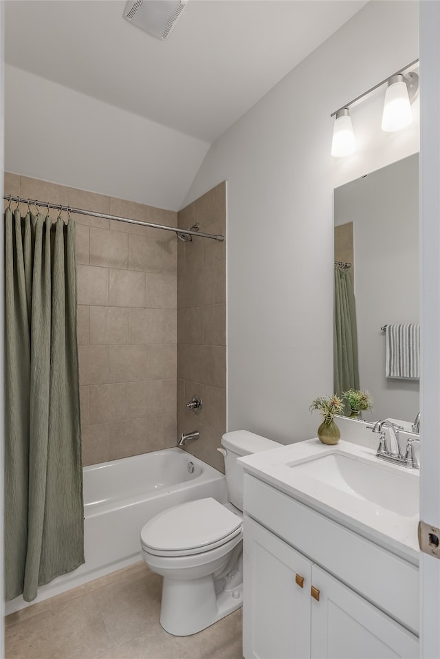 full bathroom featuring shower / tub combo with curtain, toilet, tile patterned floors, vanity, and vaulted ceiling