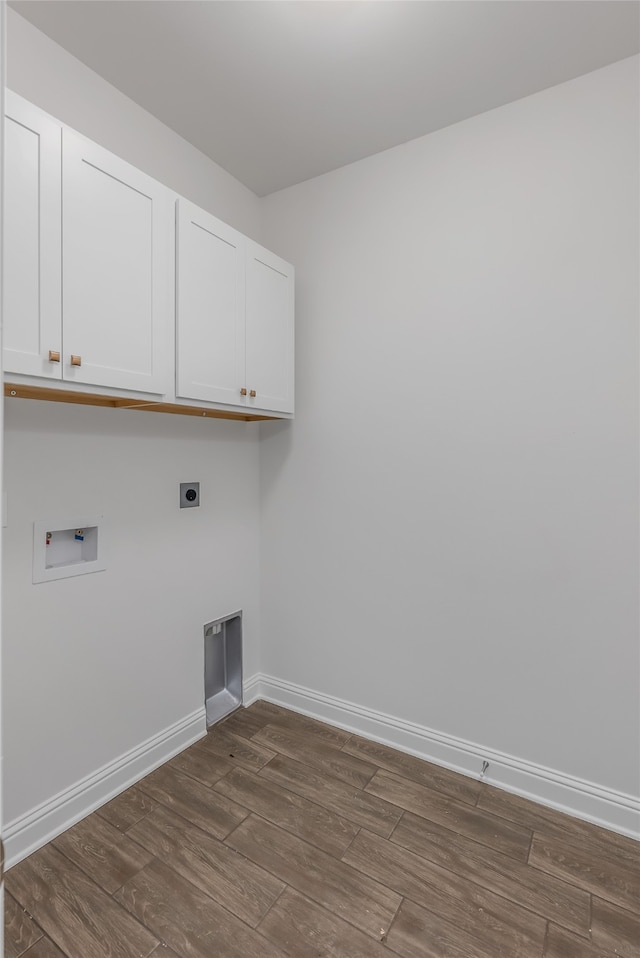 clothes washing area featuring cabinets, dark hardwood / wood-style flooring, and washer hookup