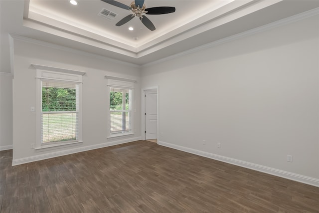 unfurnished room featuring ceiling fan, hardwood / wood-style flooring, and a raised ceiling