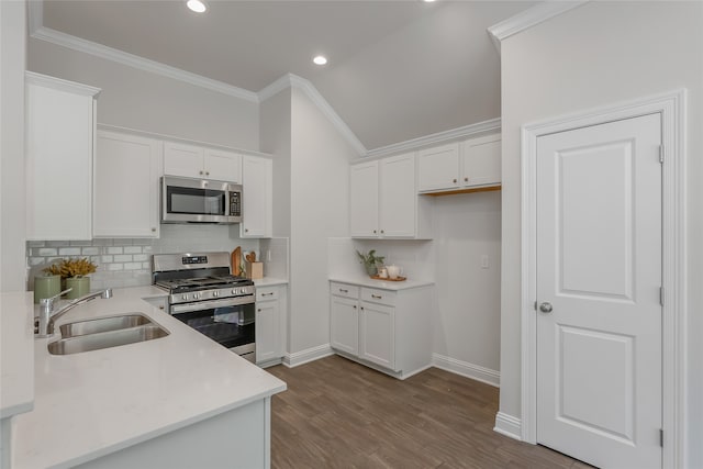 kitchen featuring appliances with stainless steel finishes, backsplash, white cabinets, light hardwood / wood-style flooring, and sink