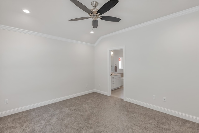 unfurnished bedroom with ensuite bath, vaulted ceiling, crown molding, and ceiling fan