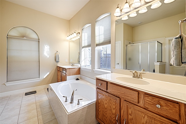 bathroom with tile patterned floors, separate shower and tub, and dual vanity