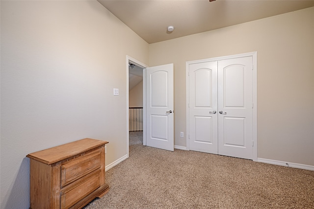 unfurnished bedroom with a closet and light carpet