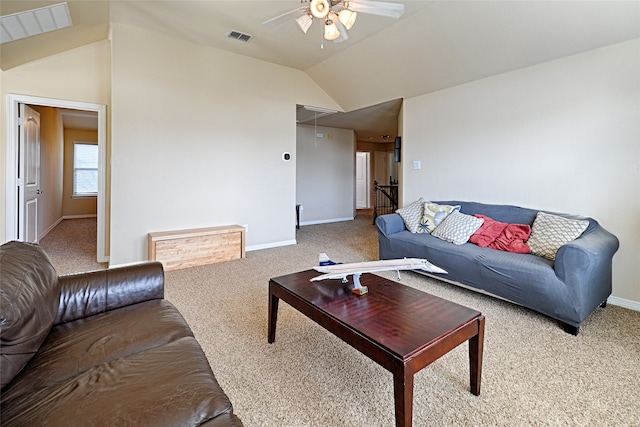 living room with ceiling fan, lofted ceiling, and carpet flooring