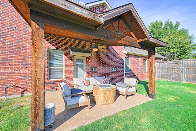 view of patio featuring ceiling fan and an outdoor living space with a fire pit