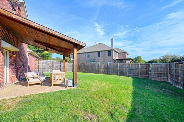 view of yard featuring a patio area and ceiling fan