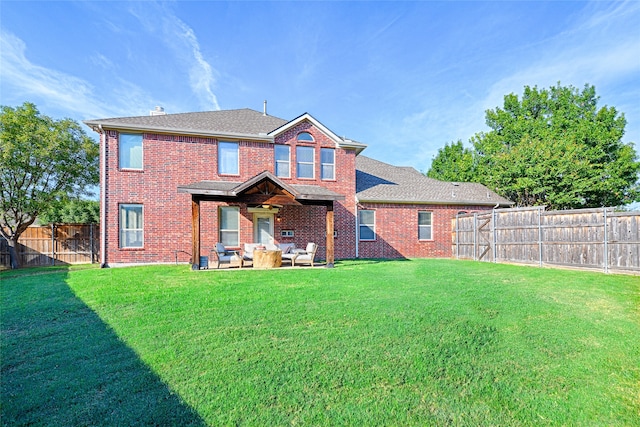 rear view of house with a patio area and a lawn