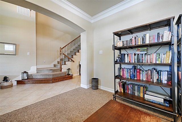 interior space with light tile patterned floors and ornamental molding