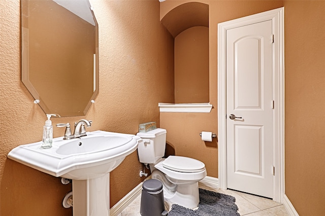 bathroom with tile patterned flooring and toilet