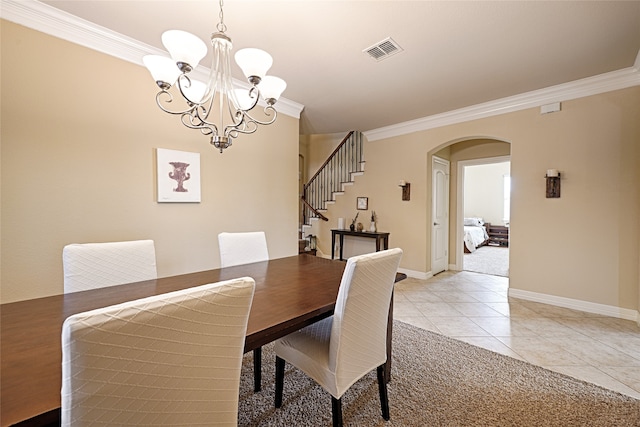 carpeted dining area featuring a chandelier and ornamental molding