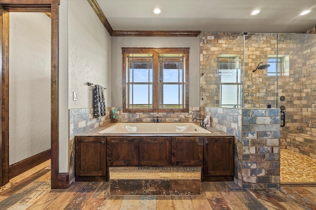 bathroom featuring a shower stall, recessed lighting, a garden tub, and ornamental molding