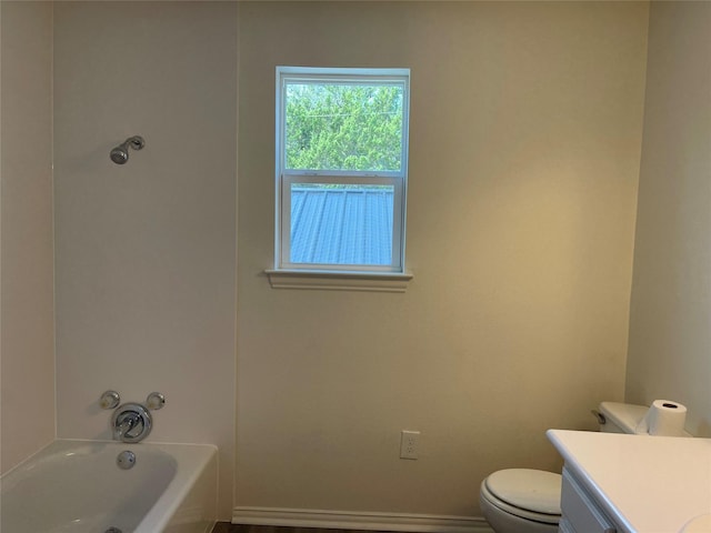 full bathroom with toilet, vanity, and baseboards