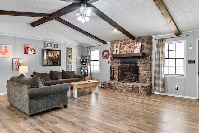 living room with light hardwood / wood-style flooring, lofted ceiling with beams, a textured ceiling, and ceiling fan