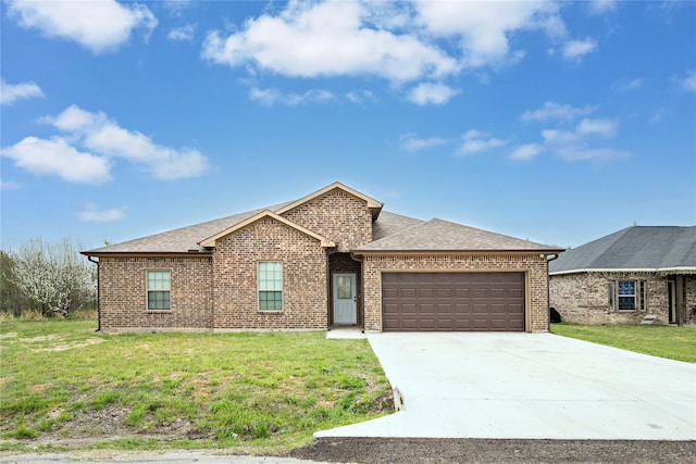 view of front of property with a garage and a front yard