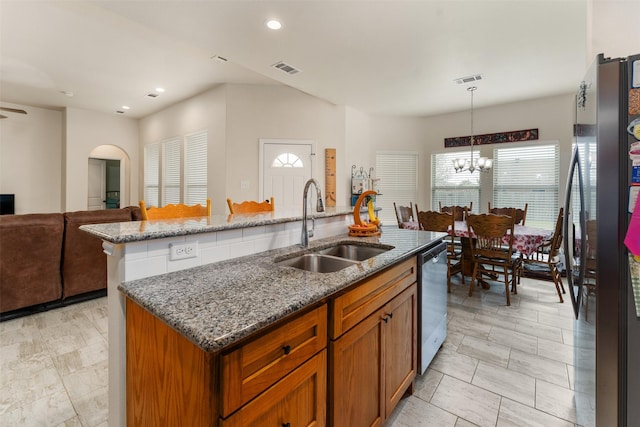 kitchen featuring a kitchen island with sink, hanging light fixtures, sink, a healthy amount of sunlight, and appliances with stainless steel finishes