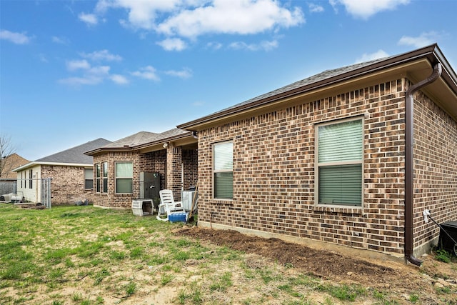 rear view of property with a lawn