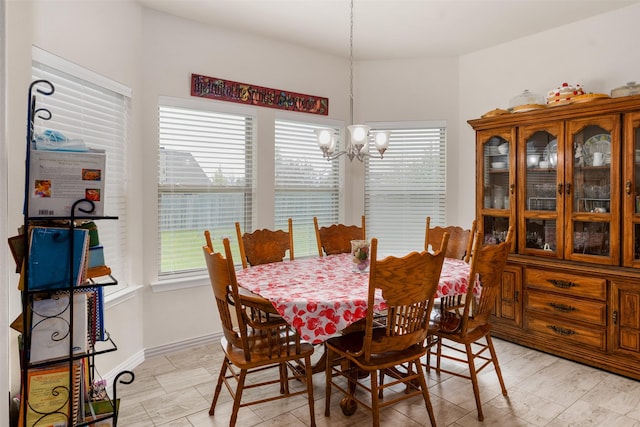 dining room with a notable chandelier and plenty of natural light