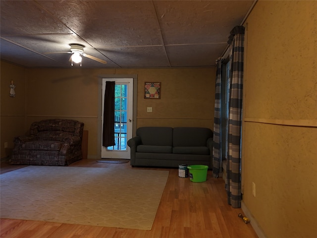 living room with hardwood / wood-style flooring and ceiling fan