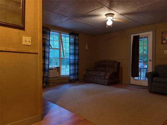 unfurnished room featuring cooling unit, hardwood / wood-style floors, a healthy amount of sunlight, and ceiling fan