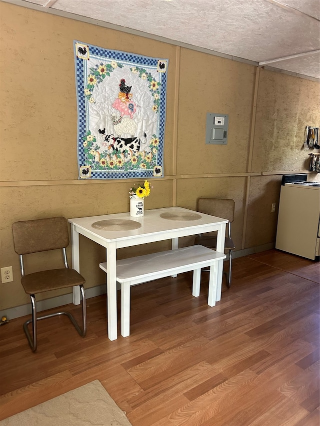 dining space with hardwood / wood-style flooring