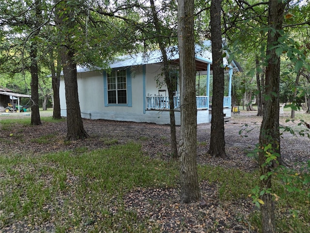 view of side of home featuring a porch