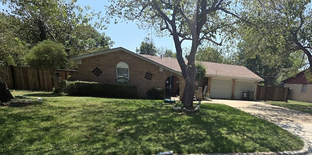 ranch-style home with a garage and a front lawn