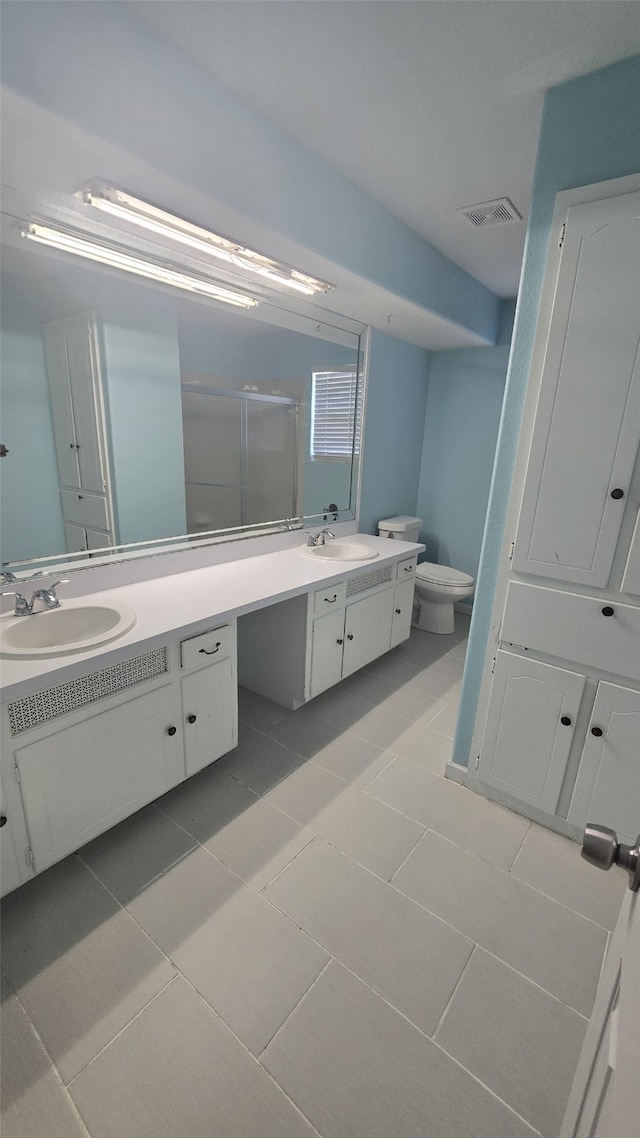 bathroom with tile patterned floors, vanity, and toilet