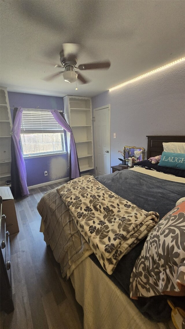 bedroom featuring a textured ceiling, hardwood / wood-style floors, and ceiling fan