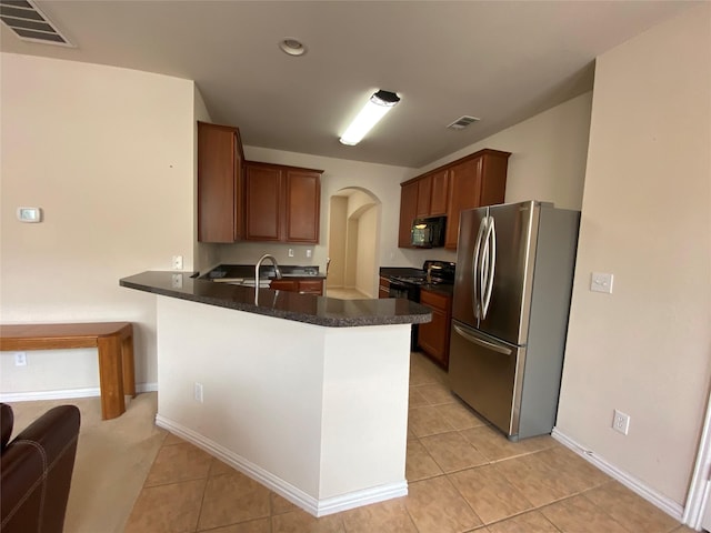 kitchen with sink, light tile patterned floors, black appliances, and kitchen peninsula