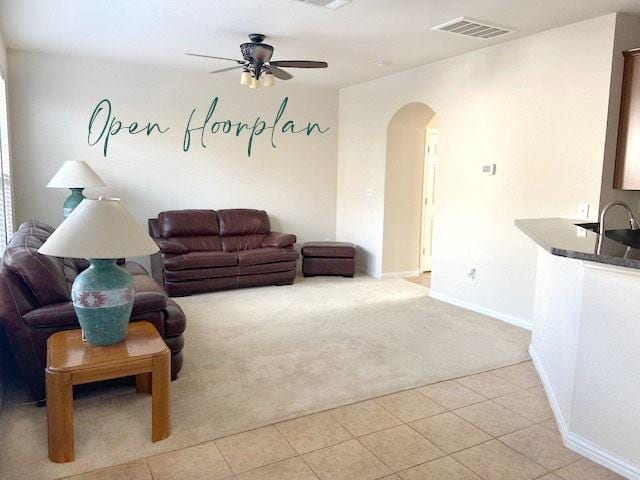 living room featuring ceiling fan and light colored carpet