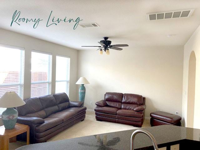 living room with carpet and ceiling fan