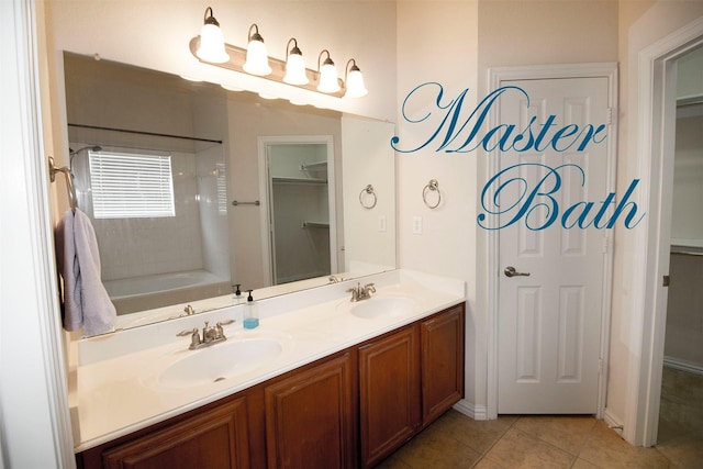 bathroom with vanity, a bathtub, and tile patterned flooring