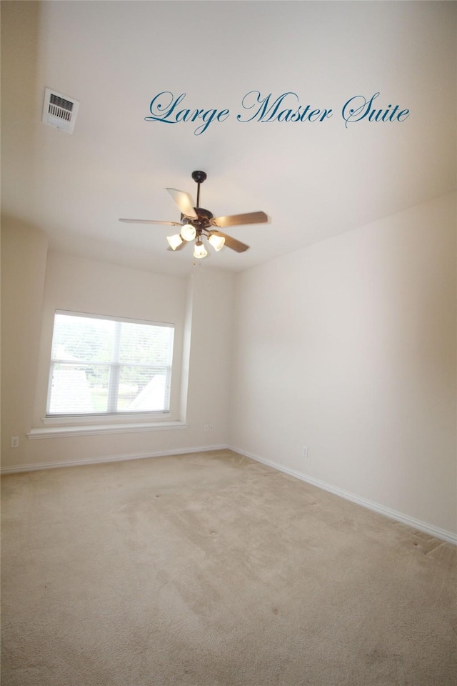 carpeted spare room with ceiling fan