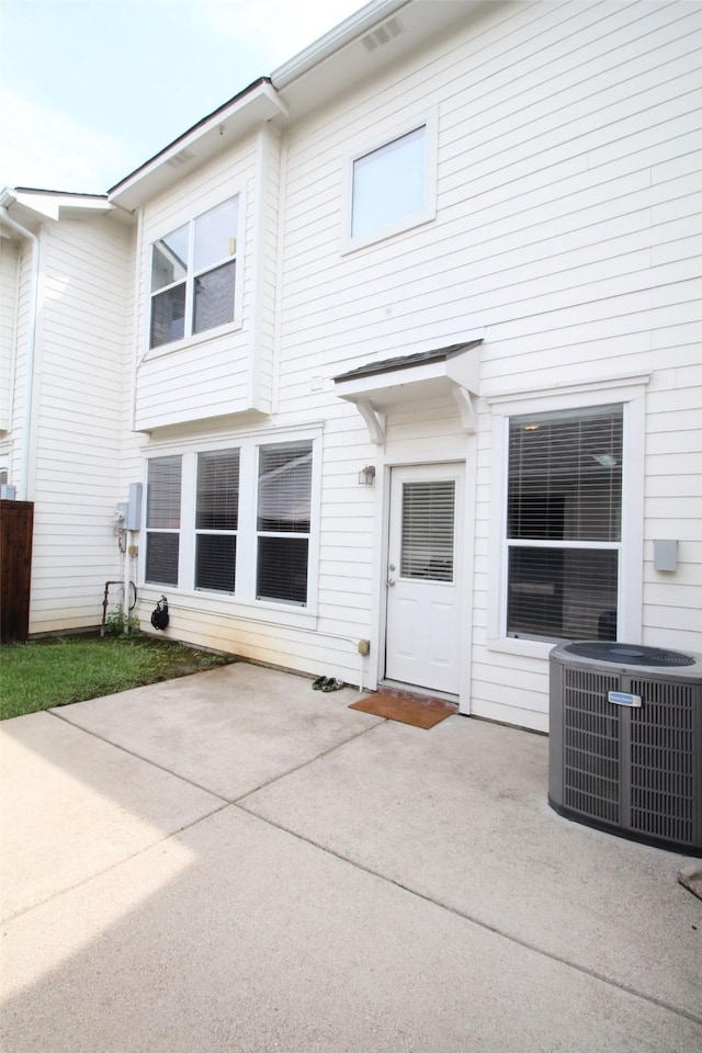 back of house with central AC and a patio