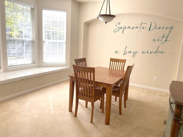 dining room featuring light carpet