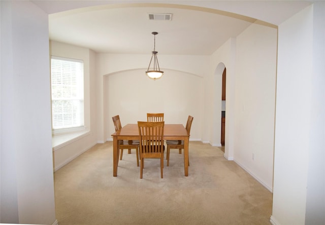 dining area featuring light carpet