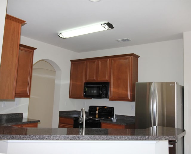 kitchen featuring kitchen peninsula, black appliances, and sink