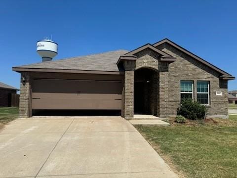 french country style house with concrete driveway, an attached garage, brick siding, and a front lawn