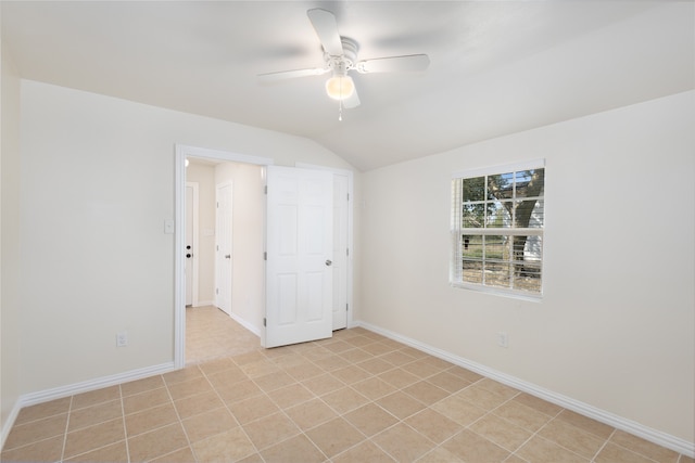 spare room featuring lofted ceiling and ceiling fan