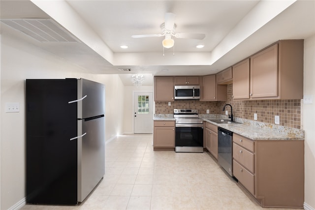 kitchen featuring light brown cabinets, light tile patterned flooring, sink, backsplash, and stainless steel appliances